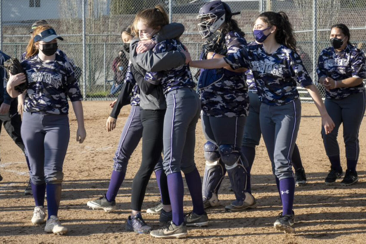 Heritage slowpitch softball players celebrate a win over Prairie this season (Photo courtesy of Troy Wayrynen, Heritage High School)