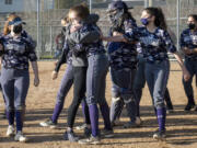 Heritage slowpitch softball players celebrate a win over Prairie this season (Photo courtesy of Troy Wayrynen, Heritage High School)