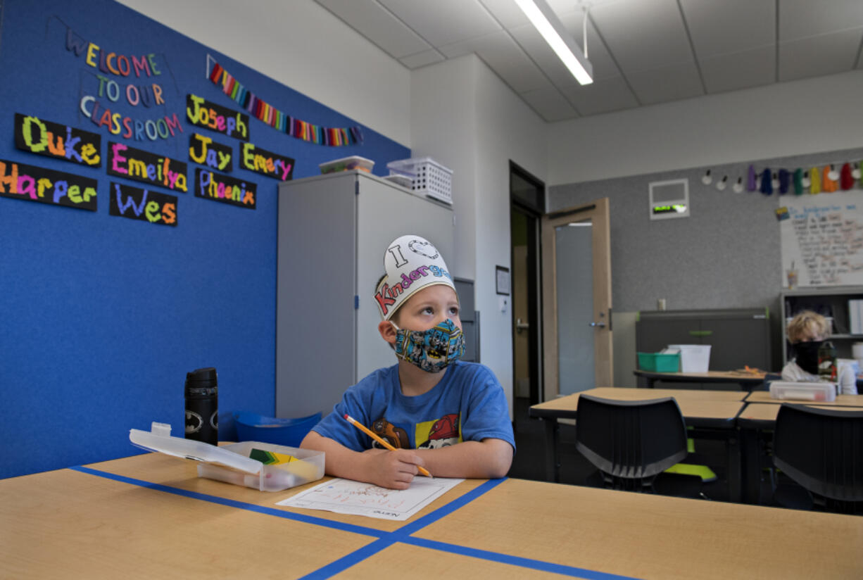 Sifton Elementary kindergarten student Phoenix Winmil wears a hat that reads &quot;I love Kindergarten&quot; during his second day of in-person learning in September. Enrollment is what drives staffing for districts, which is why districts have one message: the sooner families enroll students, the better.