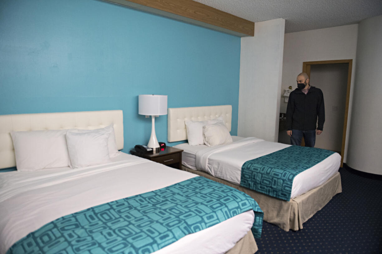 Andy Silver, director of supportive services at the Vancouver Housing Authority, looks over one of the 63 rooms that will be available for homeless residents at the former Howard Johnson hotel during a tour in February.