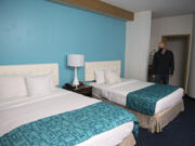 Andy Silver, director of supportive services at the Vancouver Housing Authority, looks over one of the 63 rooms that will be available for homeless residents at the former Howard Johnson hotel during a tour in February.