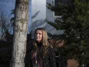 Melissa Pond, who works in COVID-19 response for Clark County Public Health, pauses for a portrait outside Public Health&#039;s building in Vancouver. Pond lost an uncle to the virus and also contracted it herself in the fall.