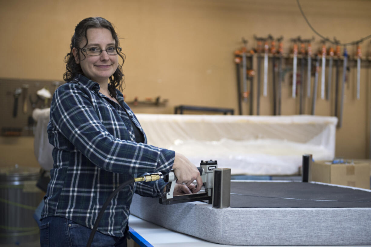 Harmony Roselli, upholsterer and co-owner at Roselli's Restoration, pauses for a portrait while working in her Vancouver warehouse Wednesday afternoon, March 3, 2021.