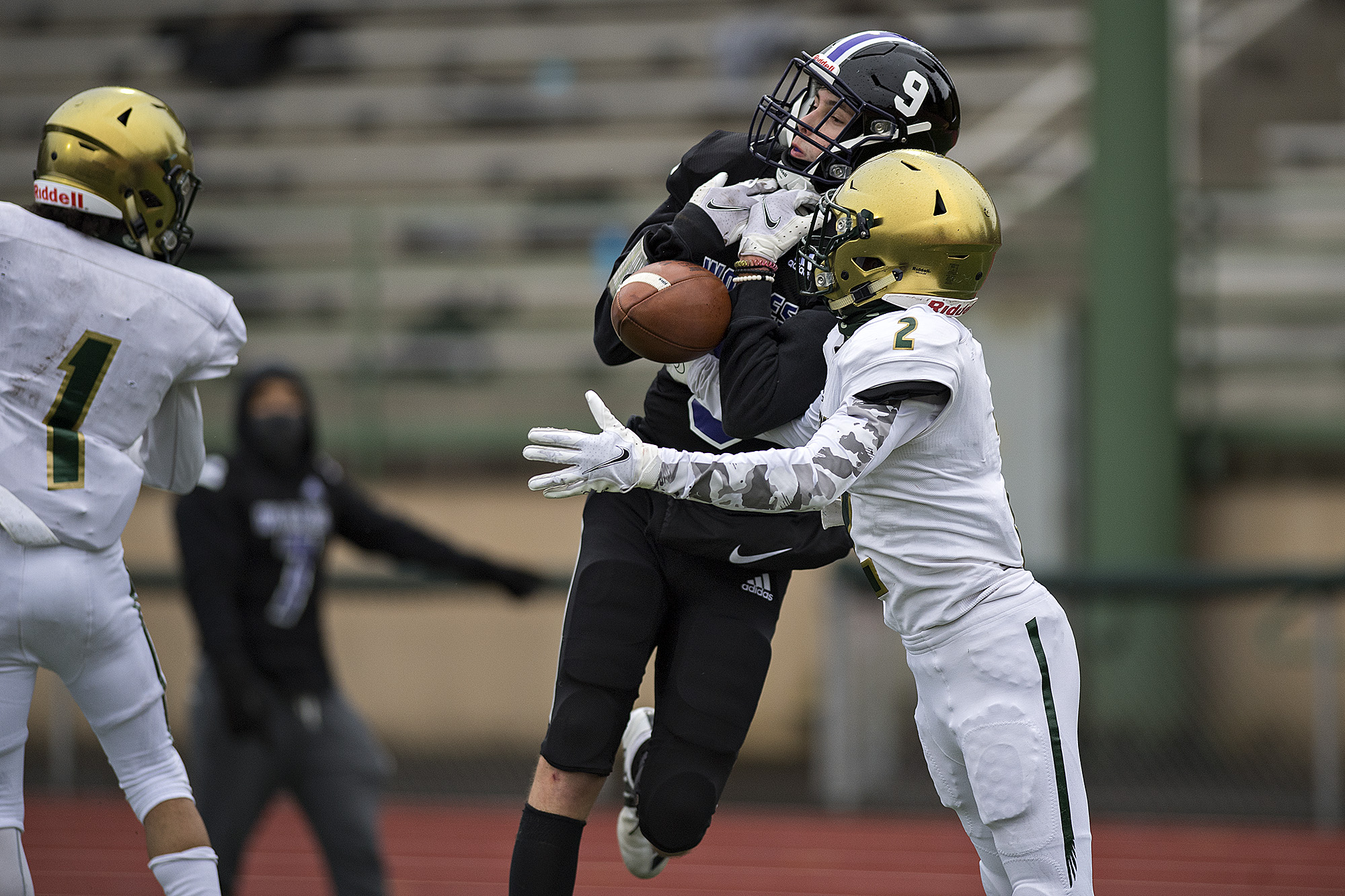 Heritage receiver Alex Anderson (9) is unable to hang onto a pass as Evergreen defender Jonathan Simon (2) breaks up the play in the second quarter as stands at McKenzie Stadium are empty due to COVID-19 concerns on Friday afternoon, March 5, 2021.
