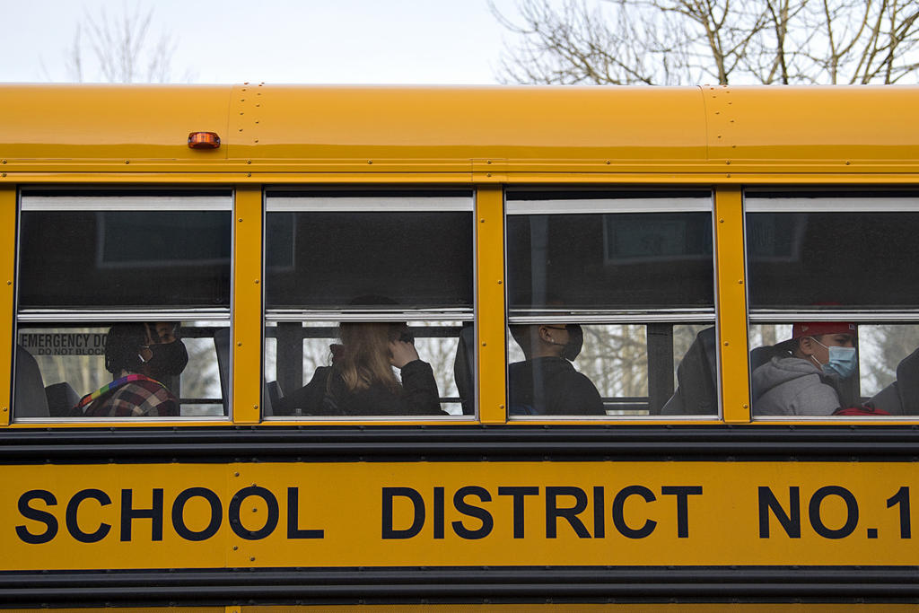 Heritage High School students wear masks as they arrive for in-person classes on Thursday morning, March 4, 2021. Teachers and staff welcomed back students in all high school grades for the first time since March 13 when schools closed for coronavirus.