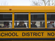 Heritage High School students wear masks as they arrive for in-person classes on Thursday morning, March 4, 2021. Teachers and staff welcomed back students in all high school grades for the first time since March 13 when schools closed for coronavirus.