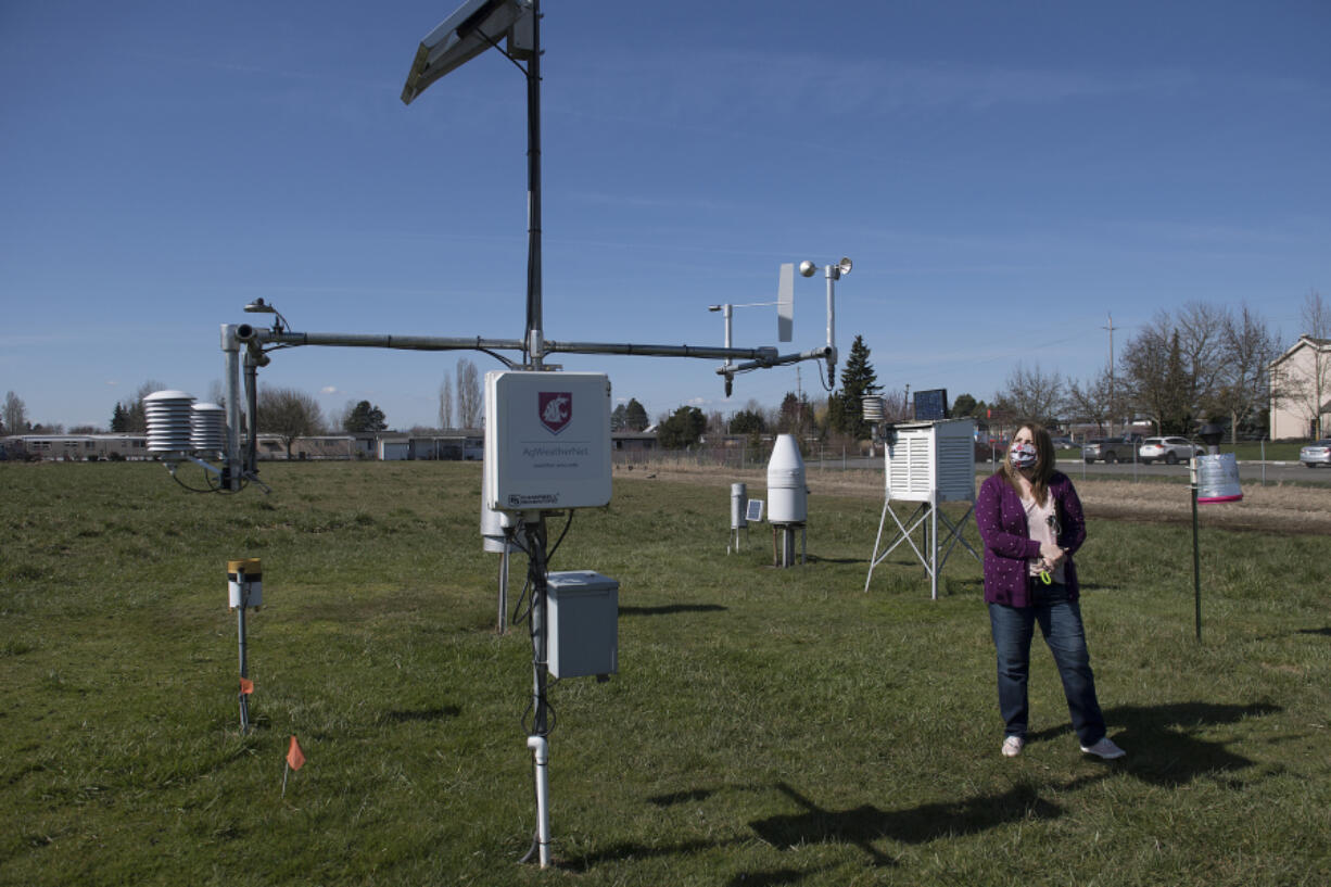 Annette Vary-Getty of Washington State University looks over the current tower of a weather station at the 78th Street Heritage Farm on a recent Friday morning. The tower is set to get a 21st century upgrade.