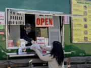 Cashier Amber Ounaphom of WanSook Thai Food, left, hands an order to customer Cearah Hiatt of Vancouver. New restaurants like WanSook are able to start from scratch and build a business model up, they said, and having a food cart makes fewer worries than brick-and-mortar indoor spots.&quot;It&#039;s easier, smaller and has less overhead,&quot; co-owner David Hardin said.