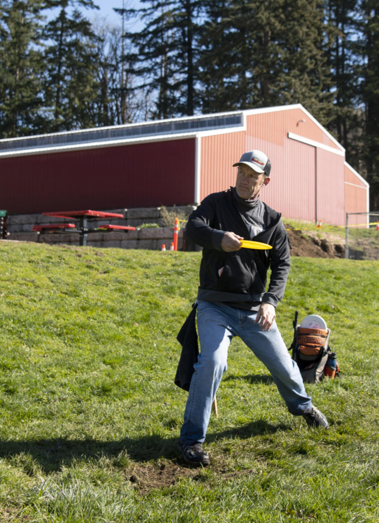 Washougal resident Pete Knight throws his disc on the 13th hole of the site of the new Hartwood Park disc golf course on Thursday in Washougal. The city is scheduled to open a disc golf course and community garden in April.