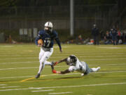 Skyview quarterback Clark Coleman evades a tackle by Union's Jaden Hornsby en route to scoring a touchdown at Kiggins Bowl on Friday night, March 12, 2021.