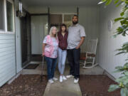 Robin Meyers, Tia Lee, 16, and Mychal Jones stand outside their Vancouver rental home on Saturday. Jones has fallen $14,000 behind on rent since he lost his second job during the pandemic and is hoping to work out a payment plan with the landlord.