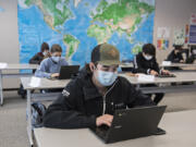 Skyview High School sophomore Joe Watson, 16, center, joins classmates during English class on Monday. Vancouver Public Schools welcomed high school students across all grades into hybrid learning. It&#039;s their first day back in the classroom since schools shut down March 13, 2020.