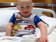 Braxton Manring, 2, smiles while in the hospital for treatment of a blood disorder similar to leukemia.