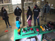 Adriane Savelli, one of the organizers of the nonprofit Vancouver Tool Library, from left, joins Scarlett Oakes, 5, Joe Beaudoin, Allonah Podvin, Roman Garrison and David Hagan at the former Joe&#039;s Place Farms earlier this month. The group was looking over items that Beaudoin donated and is storing until the tool library finds a location.