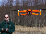 Washington Department of Fish and Wildlife habitat biologist George Fornes flies a drone near the North Fork of the Toutle River to survey potential locations for a new fish release site on Wednesday.