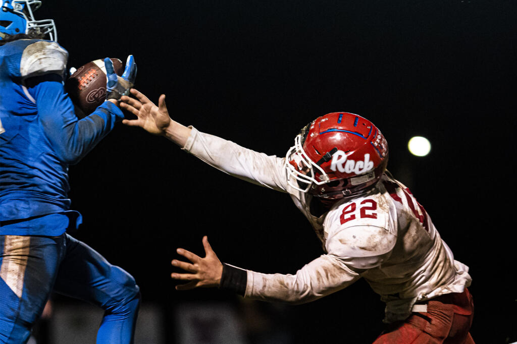 La Center's Jeremy Humphrey intercepts a pass intended for Castle Rock’s Landon Gardner during a game at La Center High School on Friday night, March 19, 2021.