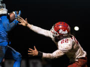 La Center's Jeremy Humphrey intercepts a pass intended for Castle Rock’s Landon Gardner during a game at La Center High School on Friday night, March 19, 2021.