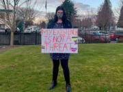 Lucy Lauser, a Democrat running for Congress in Washington&#039;s 3rd Congressional District and a transgender woman, poses with a sign.