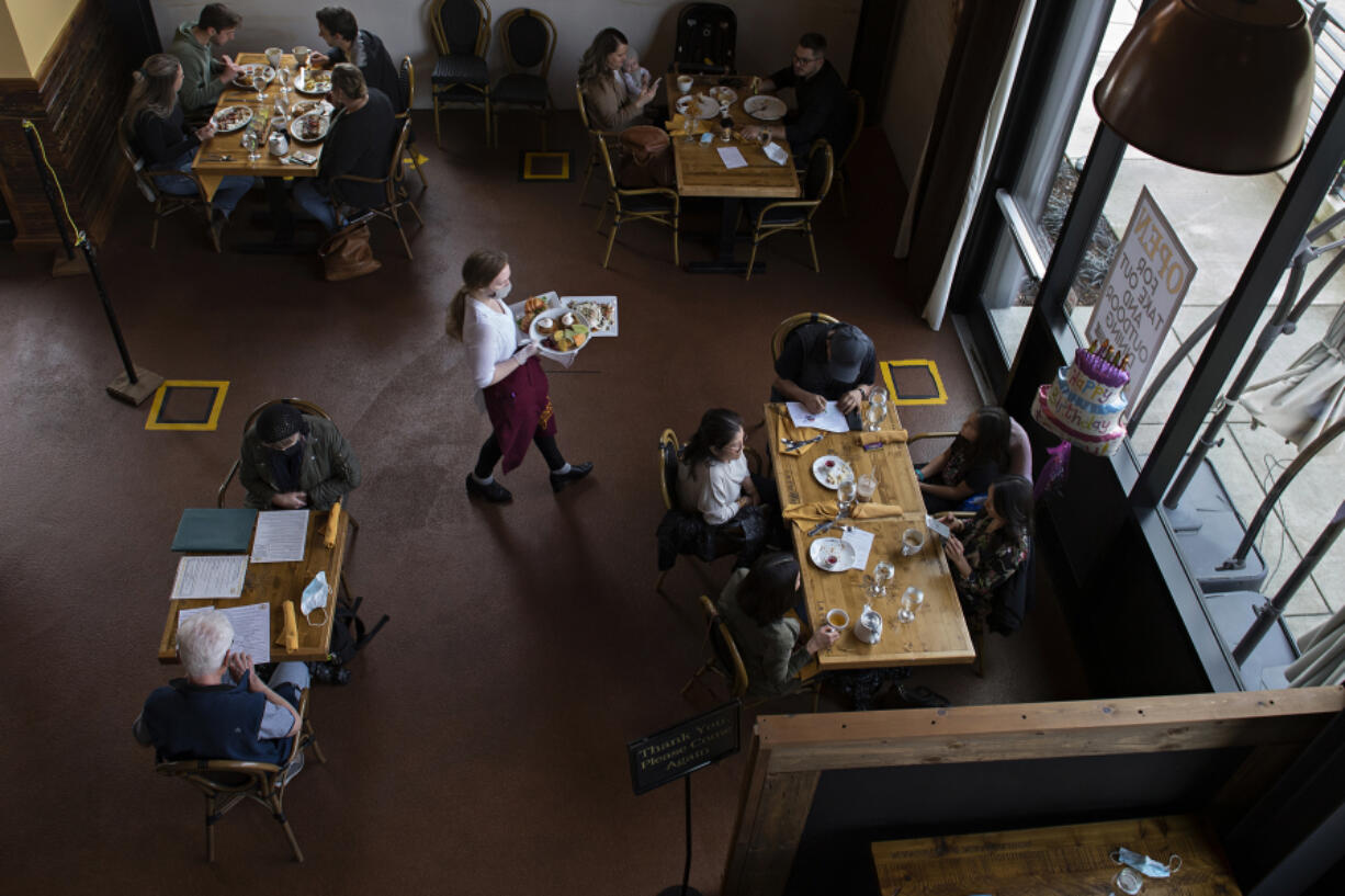 Customers dine at La Provence Vancouver&#039;s socially distanced dining area as lunch is served Thursday afternoon.