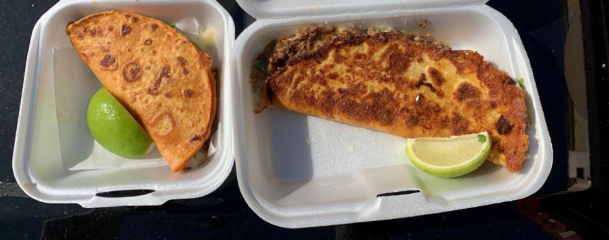 A birria cheese taco and queso birria from Su Casa Marquez. Birria is meat slowly simmered with a blend of chiles and spices.