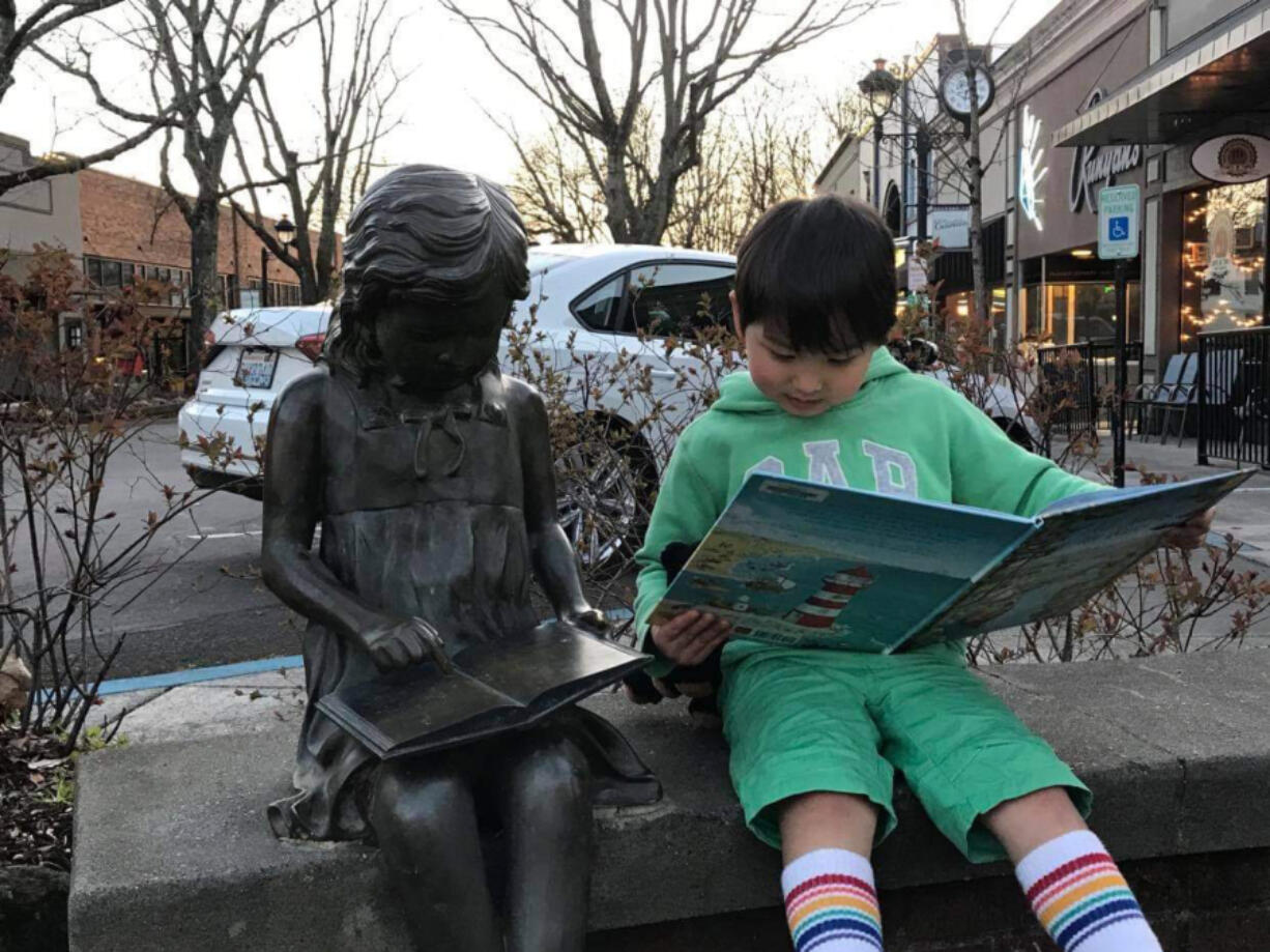 WASHOUGAL: Luca Batemen, 4, enjoys a book from the General Federation of Women&#039;s Clubs Camas-Washougal.