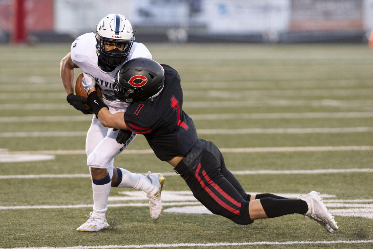 Camas’ Gabe Guo tackles Skyview’s Xavier Owens in a 4A Greater St. Helens League football game on Tuesday, March 23, 2021, at Doc Harris Stadium in Camas.  The Papermakers won 38-31 in double overtime.