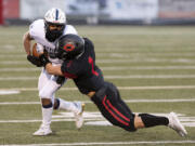 Camas’ Gabe Guo tackles Skyview’s Xavier Owens in a 4A Greater St. Helens League football game on Tuesday, March 23, 2021, at Doc Harris Stadium in Camas.  The Papermakers won 38-31 in double overtime.