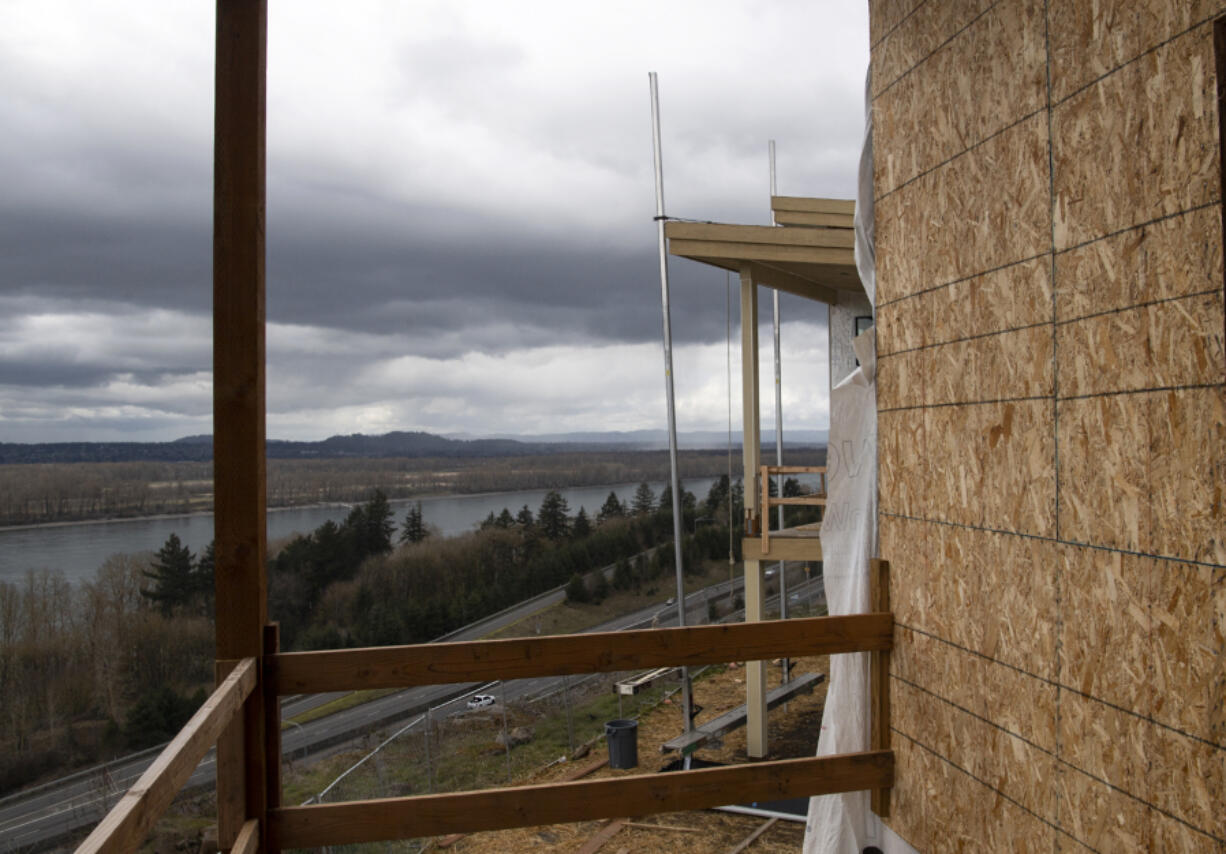 Cars bustle down Highway 14, hundreds of feet below the deck of a town home at the Boulder Ridge development in the Columbia Palisades neighborhood on the border of Vancouver and Camas. The Boulder Ridge development is expected to be complete within a year.