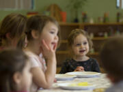 Kenya Greenberg, 3, facing, joins fellow preschoolers as they sing a Passover song before the holiday at Chabad Jewish Center on Friday morning, March 26, 2021.