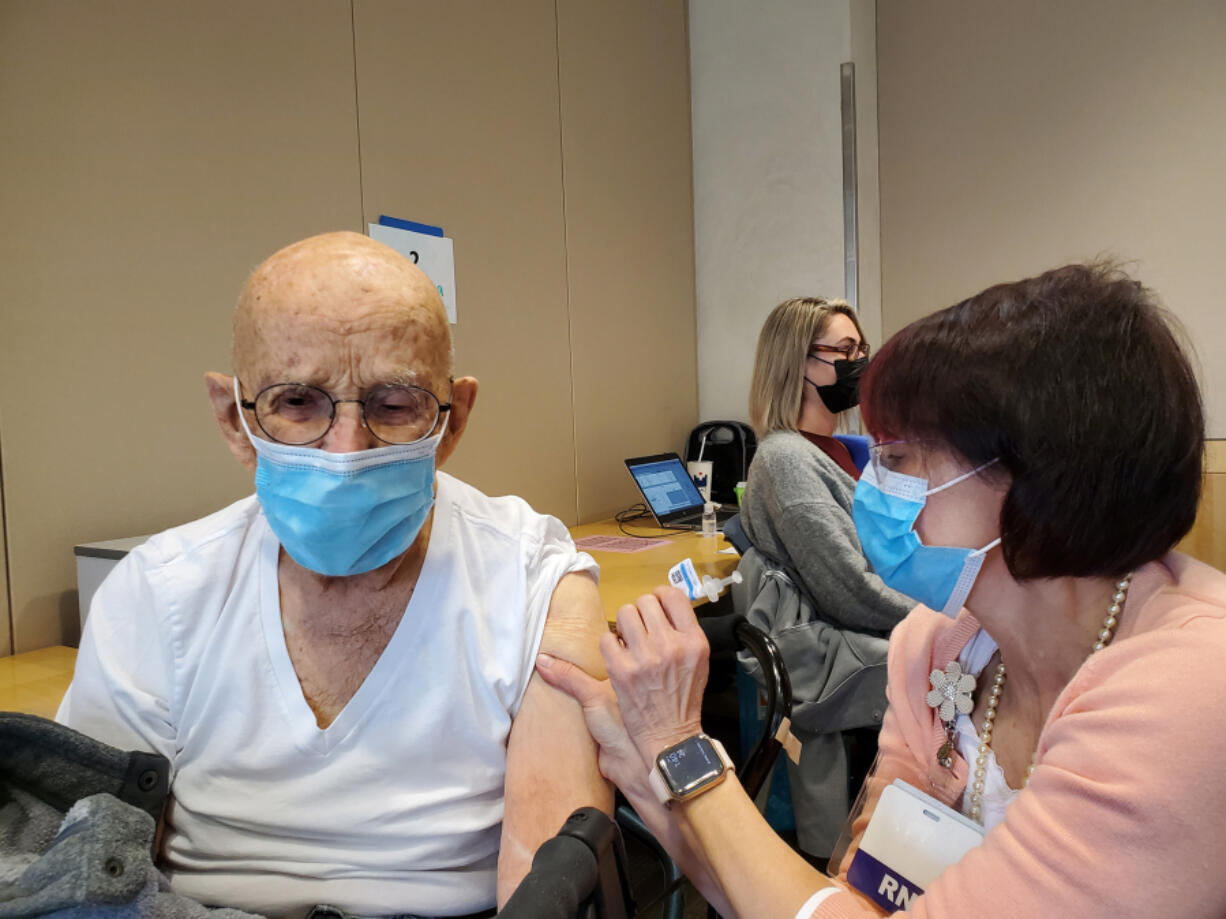 Earl Bolton receives his second dose of the COVID-19 vaccine in late March at Legacy Salmon Creek Medical Center in Salmon Creek.