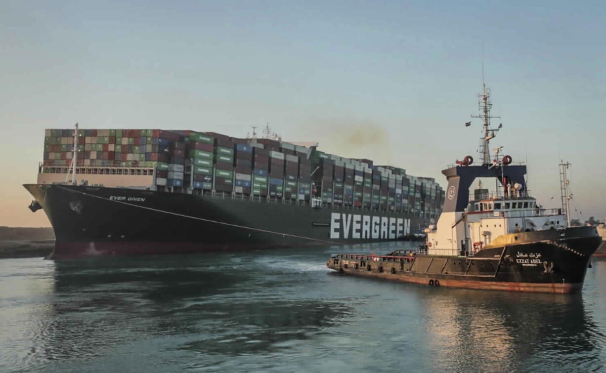 In this photo released by Suez Canal Authority, the Ever Given, a Panama-flagged cargo ship, is pulled by one of the Suez Canal tugboats, in the Suez Canal, Egypt, Monday, March 29, 2021. Engineers on Monday &quot;partially refloated &quot; the colossal container ship that continues to block traffic through the Suez Canal, authorities said, without providing further details about when the vessel would be set free.