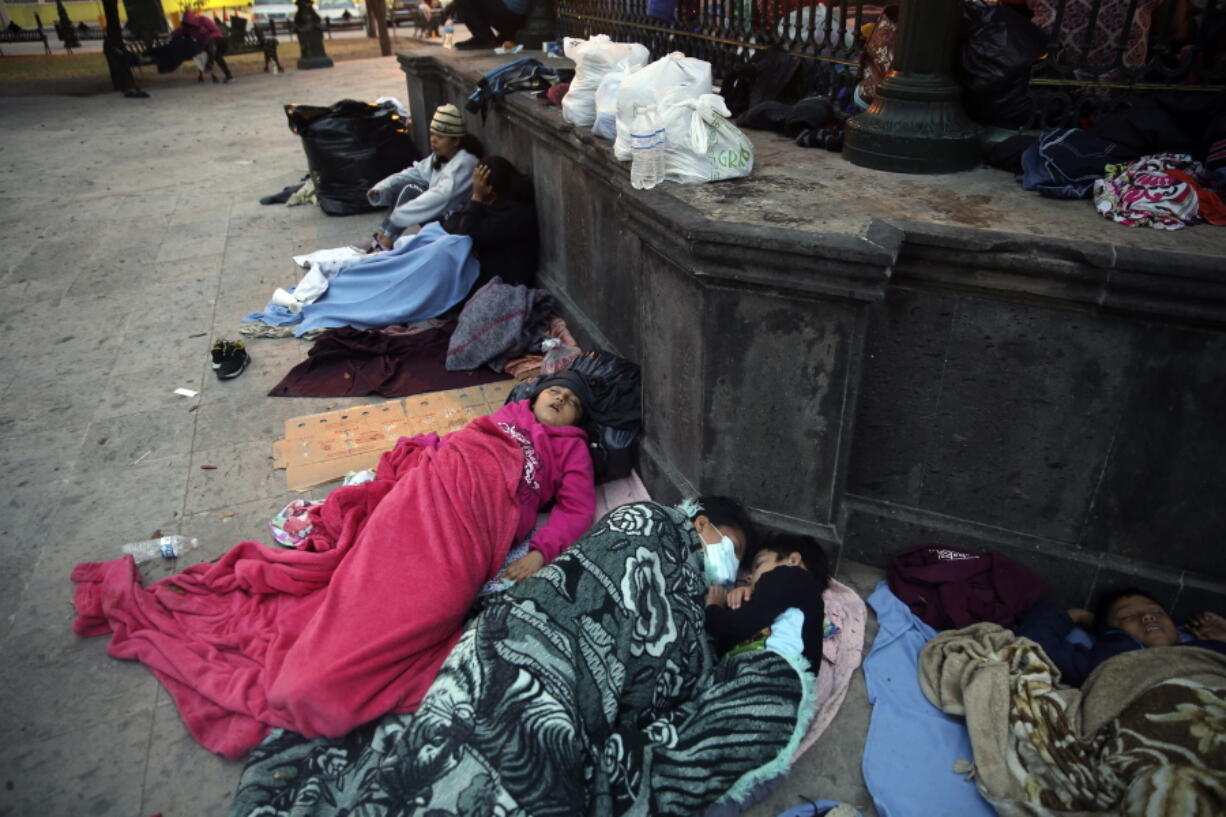 Migrants sleep under a gazebo at a park in the Mexican border city of Reynosa, Saturday, March 27, 2021. Dozens of migrants who earlier tried to cross into the U.S. in order to seek asylum have turned this park into an encampment for those expelled from the U.S. under pandemic-related presidential authority.