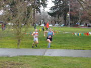 Hockinson's Allyson Peterson (front) leads Washougal's Elle Thomas in the girls races at the 2A district cross country meet at Hudson's Bay High School on Thursday, March 18, 2021 (Tim Martinez/The Columbian)