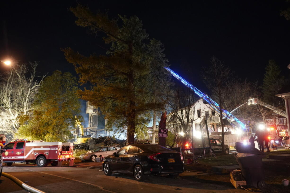 Firefighters continue working a fire, late Tuesday, March 23, 2021, that burned down the Evergreen Court Home for Adults in Spring Valley, N.Y. The fire swept through the suburban New York assisted living home and caused a partial collapse earlier in the day.