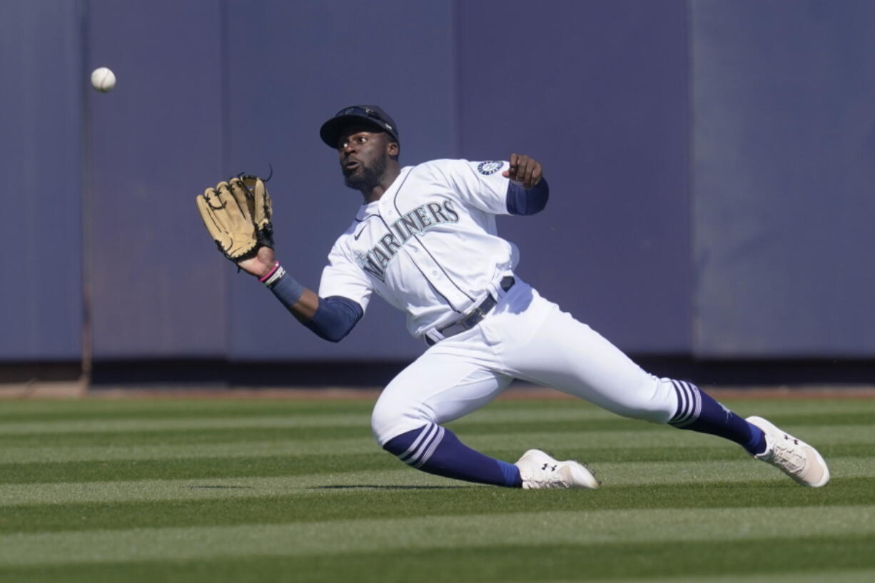 Seattle Mariners center fielder Taylor Trammell catches a fly ball hit by Oakland Athletics&#039; Greg Deichmann during the second inning of a spring training baseball game Saturday, March 6, 2021, in Peoria, Ariz.