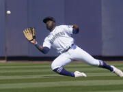 Seattle Mariners center fielder Taylor Trammell catches a fly ball hit by Oakland Athletics&#039; Greg Deichmann during the second inning of a spring training baseball game Saturday, March 6, 2021, in Peoria, Ariz.