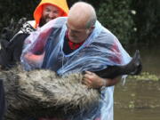 Paul Zammit carries his pet emu, Gookie, after rescuing her from floodwater in Windsor, northwest of Sydney, New South Wales, Australia, Tuesday, March 23, 2021. Hundreds of people have been rescued from floodwaters that have isolated dozens of towns in Australia&#039;s most populous state New South Wales and forced thousands to evacuate their homes as record rain continues to inundate the country&#039;s east coast.