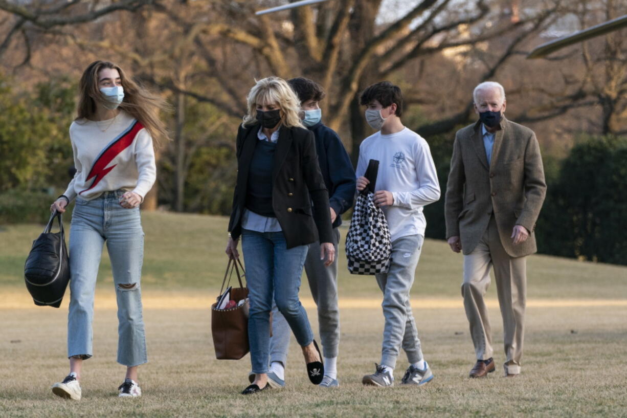 President Joe Biden and first lady Jill Biden with their grandchildren Natalie Biden and Hunter Biden, walk on the South Lawn upon arrival at the White House in Washington from a weekend trip to Wilmington, Del., Sunday, March 14, 2021.