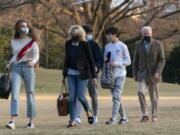 President Joe Biden and first lady Jill Biden with their grandchildren Natalie Biden and Hunter Biden, walk on the South Lawn upon arrival at the White House in Washington from a weekend trip to Wilmington, Del., Sunday, March 14, 2021.