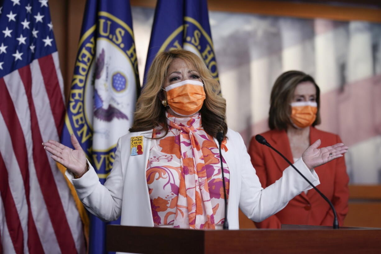 In this March 11, 2021, photo, Rep. Lucy McBath, D-Ga., whose son was a victim of gun violence, joins Speaker of the House Nancy Pelosi, D-Calif., at a news conference on passage of gun violence prevention legislation, at the Capitol in Washington. The House recently passed legislation that would require background checks for gun purchases, a signature Democratic issue for decades. But there wasn&#039;t so much as a statement issued by the White House. President Joe Biden&#039;s views on gun regulation have evolved along with his party.  (AP Photo/J.