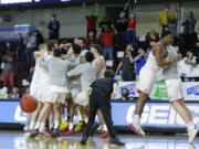 Eastern Washington players celebrate a 65-55 win over Montana State during an NCAA college basketball game for the championship of the Big Sky men&#039;s tournament in Boise, Idaho, Saturday, March 13, 2021.