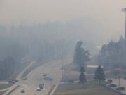 Smoke from a wildfire in the Black Hills of South Dakota blankets an area on the outskirts of Rapid City, S.D., where police set up a roadblock on Monday, March 29, 2021. There were at least three wildfires west that were burning west of Rapid City on a day when wind gusts ranged from 50 to 72 mph. The Pennington County Sheriff&#039;s Office said at least 400 homes had been evacuated and about 250 firefighters were battling the blaze that started near the town of Nemo.