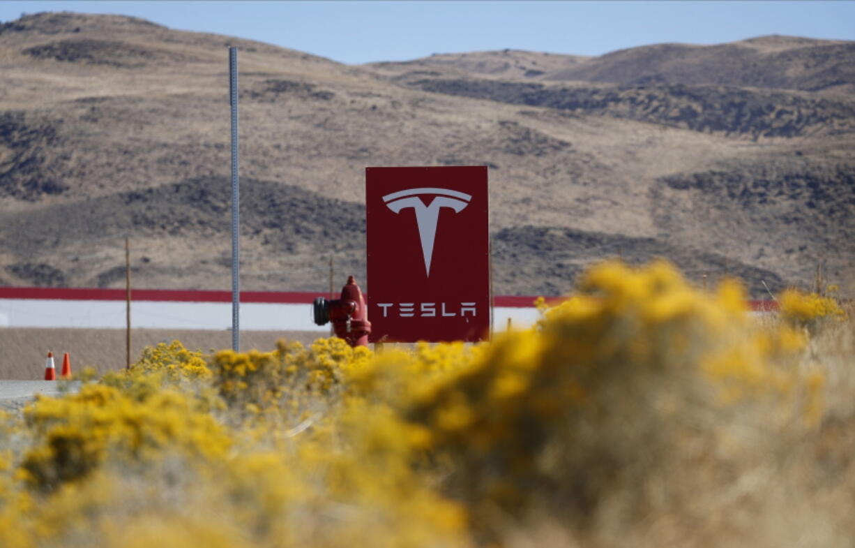 FILE - In this Oct. 13, 2018, file photo, a sign marks the entrance to the Tesla Gigafactory in Sparks, Nev. A Russian citizen has pleaded guilty to offering a Tesla employee $1 million to get malware into the electric car company&#039;s plant in Nevada and enable a ransomware attack. Attorneys representing Egor Igorevich Kriuchkov did not immediately respond Friday, March 19, 2021, to messages about his Thursday plea in U.S. District Court in Reno.