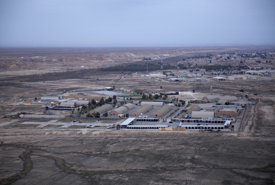 FILE  - This Dec. 29, 2019, aerial file photo taken from a helicopter shows Ain al-Asad air base in the western Anbar desert, Iraq. At least 10 rockets targeted a military base in western Iraq that hosts U.S.-led coalition troops on Wednesday, March 3, 2021, the coalition and the Iraqi military said. It was not immediately known if there were any casualties.