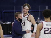 Gonzaga coach Mark Few, left, hugs forward Corey Kispert after Kispert, a senior playing his last home game, left the court near the end of the second half of the team&#039;s NCAA college basketball game against Loyola Marymount in Spokane, Wash., Saturday, Feb. 27, 2021. Gonzaga won 86-69.