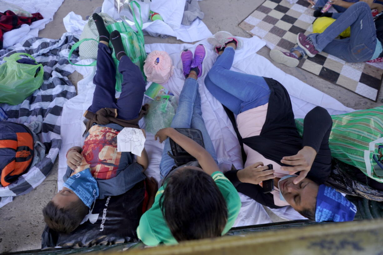 Migrants rest in a gazebo at a park after a large group of deportees were pushed by Mexican authorities off an area they had been staying after their expulsion from the U.S., Saturday, March 20, 2021, in Reynosa, Mexico. A surge of migrants on the Southwest border has the Biden administration on the defensive. The head of Homeland Security acknowledged the severity of the problem Tuesday but insisted it&#039;s under control and said he won&#039;t revive a Trump-era practice of immediately expelling teens and children. An official says U.S. authorities encountered nearly double the number children traveling alone across the Mexican border in one day this week than on an average day last month.