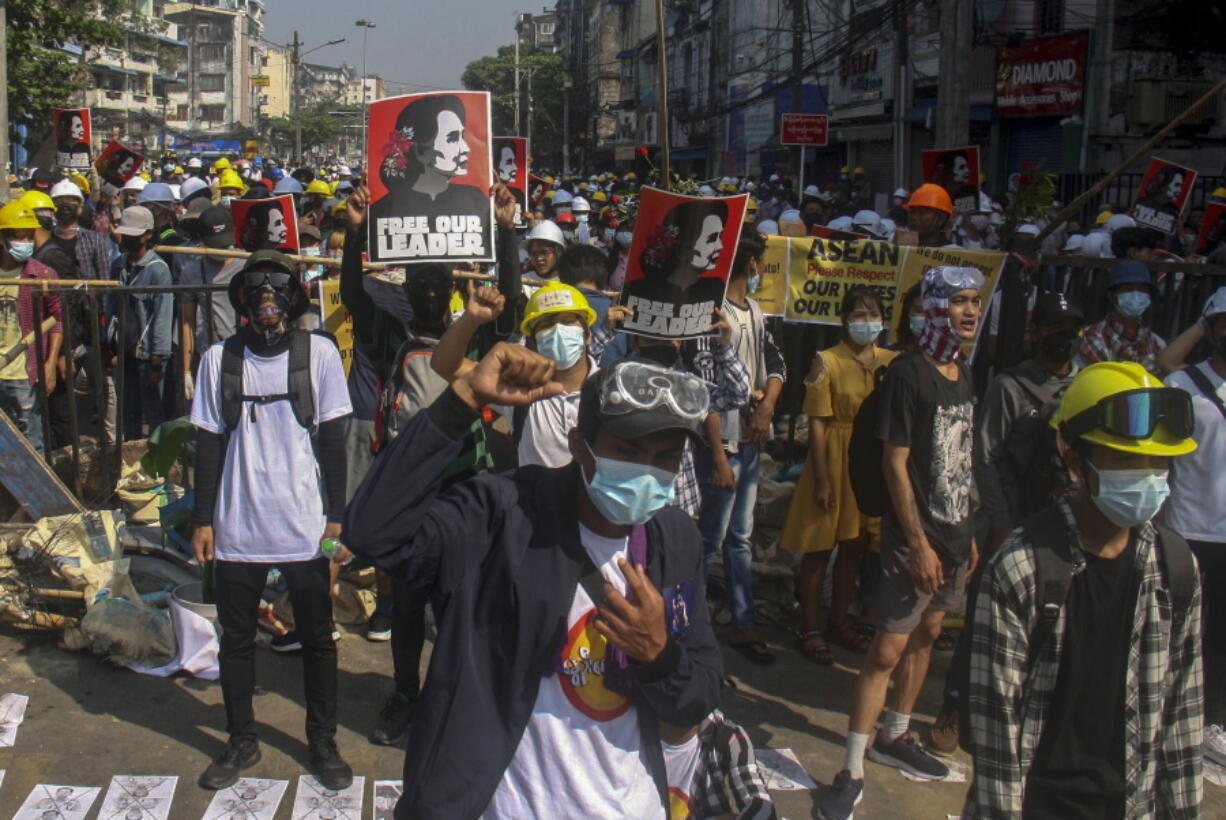 Anti-coup protesters display pictures of deposed Myanmar leader Aung San Suu Kyi in Yangon, Myanmar, Tuesday, March 2, 2021. Police in Myanmar repeatedly used tear gas and rubber bullets Tuesday against crowds protesting last month&#039;s coup, but the demonstrators regrouped after each volley and tried to defend themselves with barricades as standoffs between protesters and security forces intensified.