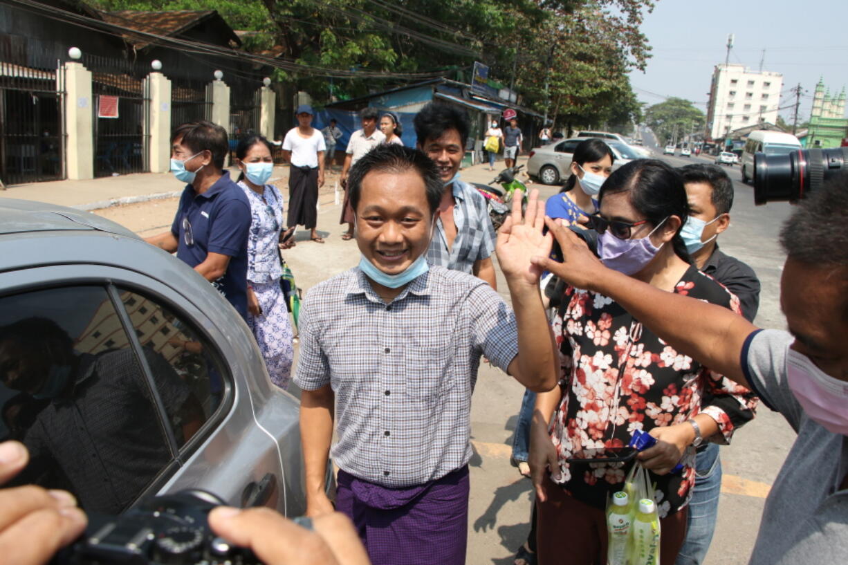 AP journalist Thein Zaw, center, waves outside Insein prison after his release Wednesday, March 24, 2021 in Yangon, Myanmar. Thein Zaw, a journalist for The Associated Press who was arrested last month while covering a protest against the coup in Myanmar, was released from detention on Wednesday.