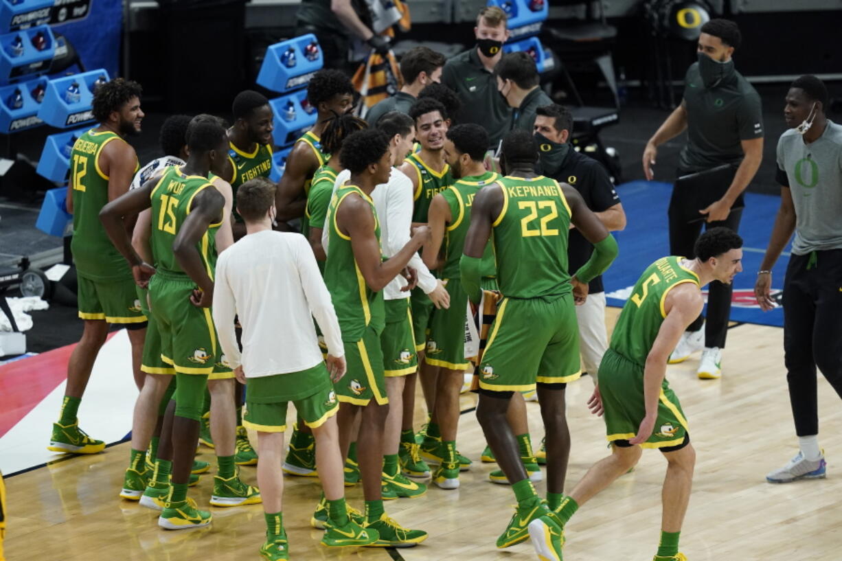 Oregon players celebrate following a second-round game against Iowa. in the NCAA men&#039;s college basketball tournament at Bankers Life Fieldhouse, Monday, March 22, 2021, in Indianapolis. Oregon won 95-80.