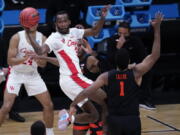 Houston guard DeJon Jarreau (3) passes over Oregon State forward Maurice Calloo (1) during the first half of an Elite 8 game in the NCAA men&#039;s college basketball tournament at Lucas Oil Stadium, Monday, March 29, 2021, in Indianapolis.